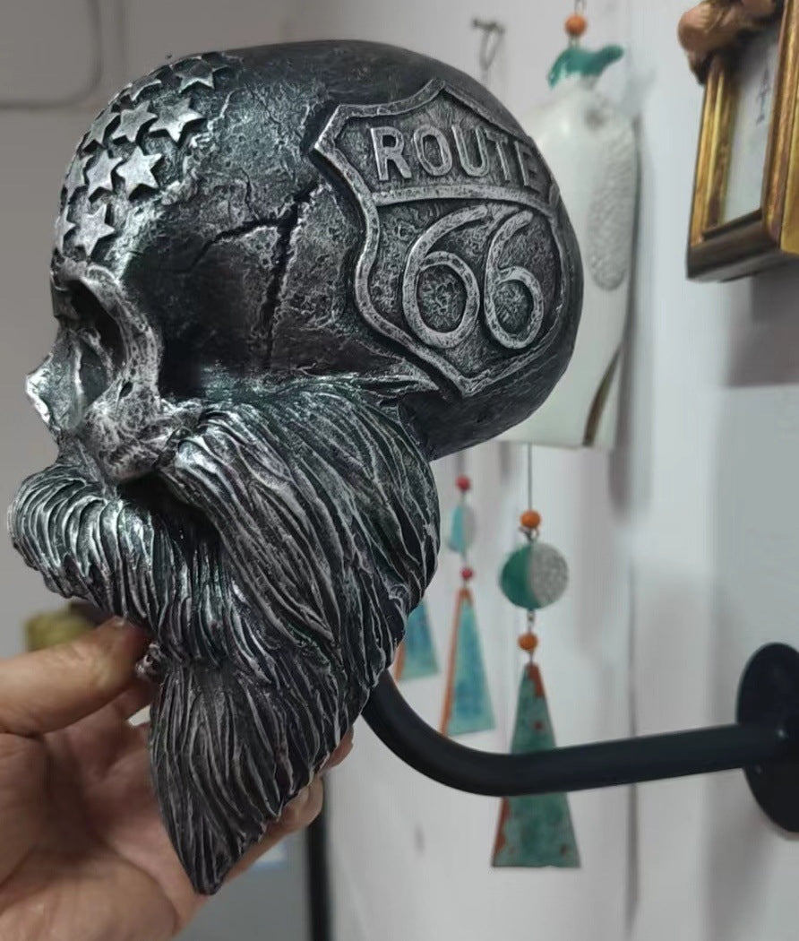 Decorative helmet holder with skull made of synthetic resin