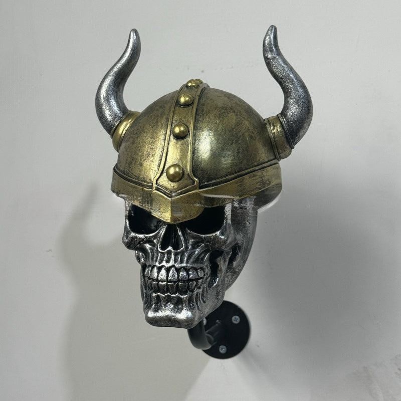 Decorative helmet holder with skull made of synthetic resin