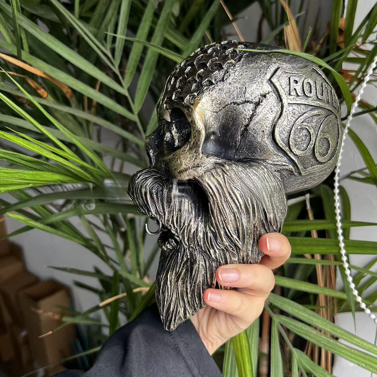 Decorative helmet holder with skull made of synthetic resin