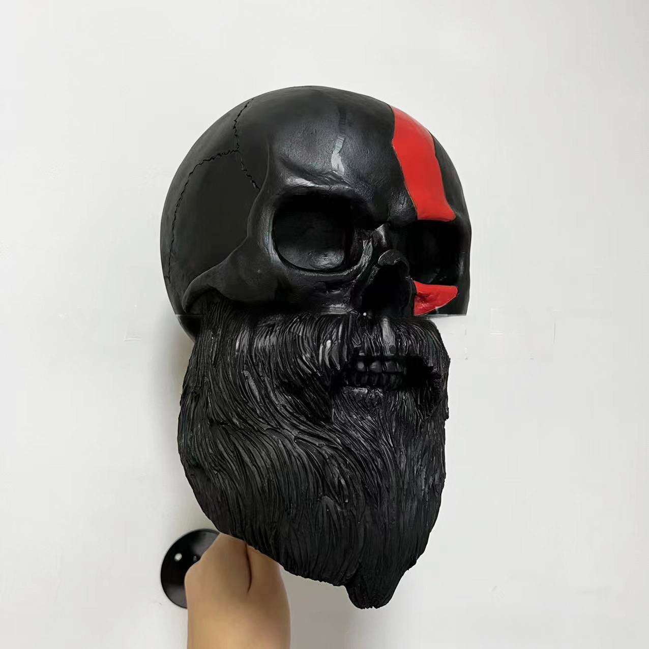 Decorative helmet holder with skull made of synthetic resin