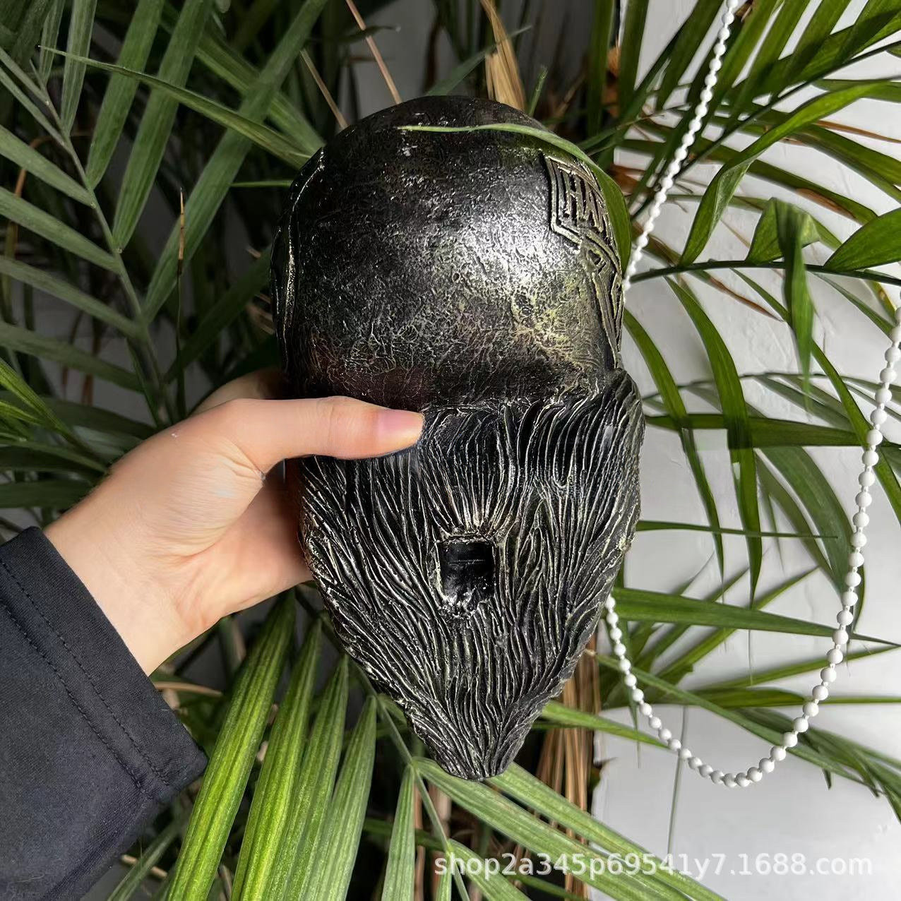 Decorative helmet holder with skull made of synthetic resin