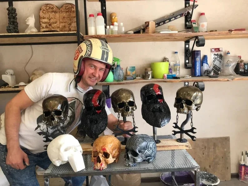 Decorative helmet holder with skull made of synthetic resin