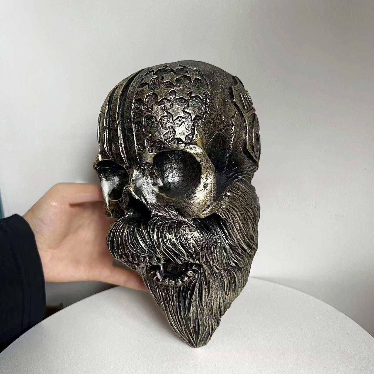 Decorative helmet holder with skull made of synthetic resin